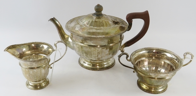 A 1930s J W Benson three piece silver tea set of fluted design, the teapot having fruit wood - Image 2 of 3