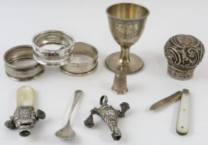 Mixed silver items including napkin rings, egg cup baby rattles thimble, fruit knife and perfume