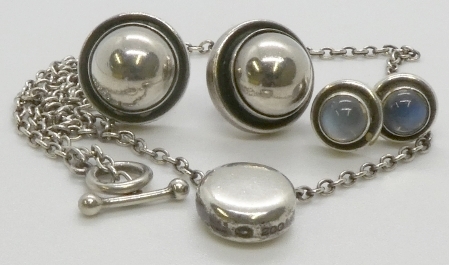 Two pairs of Georg Jensen silver earrings, one set with cabochon moonstones; and a round pendant