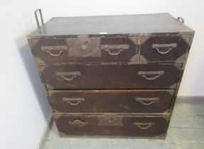 An antique Japanese Meiji Period ebonised metal bound tansu chest, housing two short above three