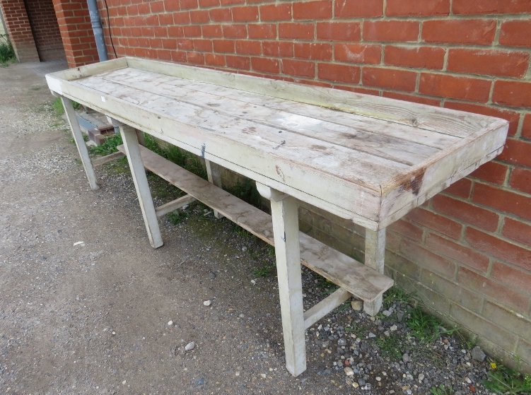 An antique pine potting bench, the galleried planked top on six square supports with stretchers. - Image 3 of 3