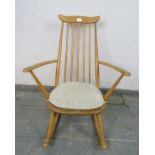 A mid-century blond elm & beech ‘Goldsmiths’ rocking chair by Ercol (model 435) on canted supports