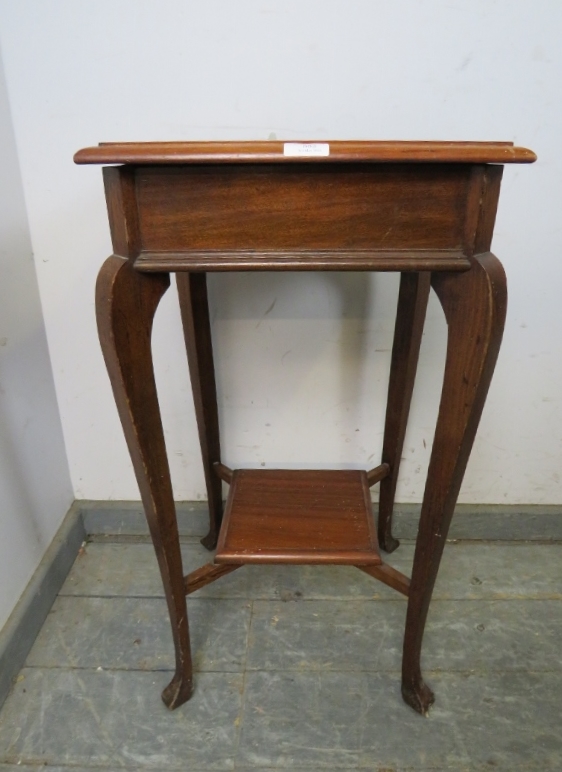 An antique mahogany square lamp table, on cabriole supports united by a braced undertier. H74cm