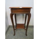 An antique mahogany square lamp table, on cabriole supports united by a braced undertier. H74cm