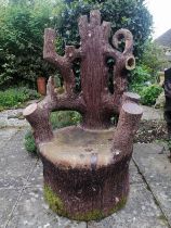 A large 19th century naturalistic stoneware garden seat, modelled as a tree stump with backrest in