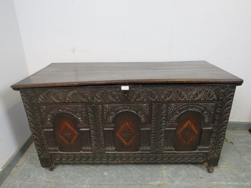 A late 17/early 18th century oak panelled coffer, having internal candle box, the front profusely