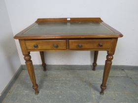 A Victorian walnut writing table, the rear gallery above an inset brown leather writing surface with