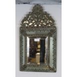 A 19th century Napoleon III cushion wall mirror, the sectioned mirror plates within a brass repousse