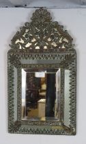 A 19th century Napoleon III cushion wall mirror, the sectioned mirror plates within a brass repousse