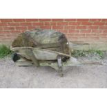 A weathered antique oak garden wheelbarrow/garden planter. H58cm W140cm D66cm (approx). Condition