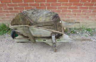 A weathered antique oak garden wheelbarrow/garden planter. H58cm W140cm D66cm (approx). Condition