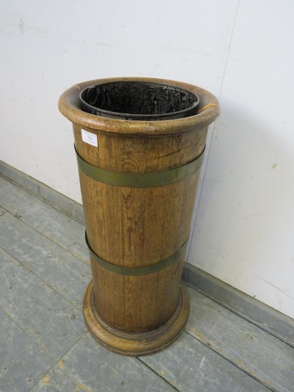 An early 20th century coopered light oak cylinder stick stand, having a tin liner, on a plinth base. - Image 2 of 3