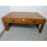 A vintage Japanese elm low coffee table, the crossbanded top above two short drawers with brass