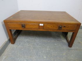 A vintage Japanese elm low coffee table, the crossbanded top above two short drawers with brass