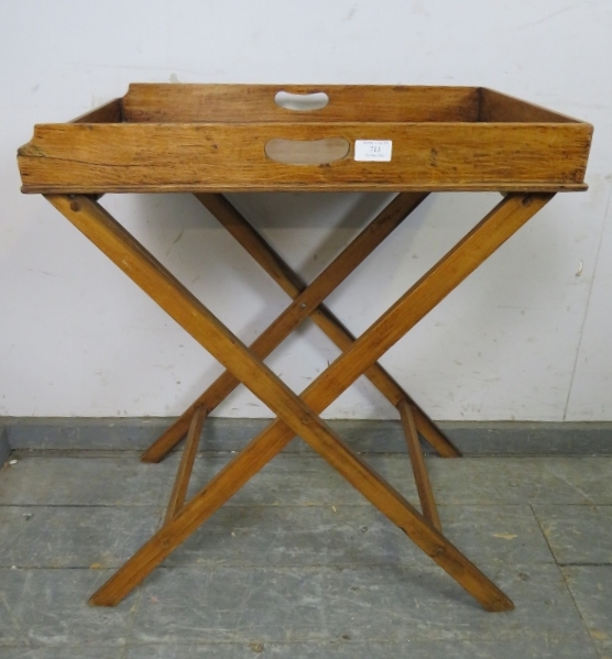 An early 20th century walnut butler’s tray on stand, the galleried tray with pierced handles to