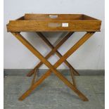 An early 20th century walnut butler’s tray on stand, the galleried tray with pierced handles to