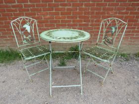 A vintage steel garden set painted green comprising a circular folding table with pierced swallow