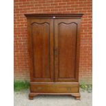 An 18th century Continental oak linen press/wardrobe, having fielded front and side panels, the