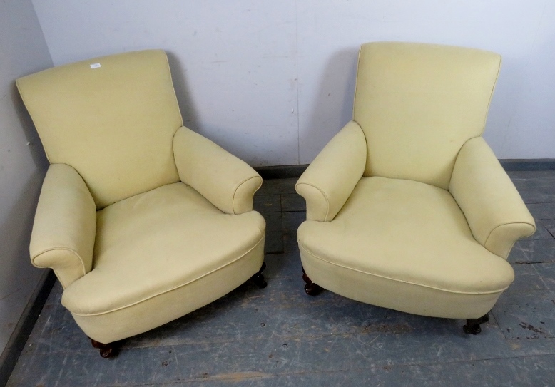 A pair of 19th century club armchairs in the manner of Howard & sons, reupholstered in pale yellow