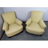 A pair of 19th century club armchairs in the manner of Howard & sons, reupholstered in pale yellow