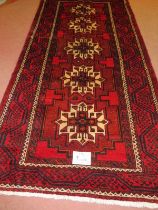 North East Persian Meshed Belouch rug, five central repeat motifs, cream on red ground. 235cm x