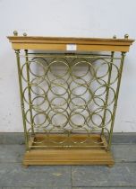 A vintage beech and brass wine rack (capacity 16 bottles) with brass ball finials, on a stepped