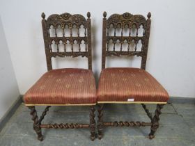 A pair of 19th century Gothic Revival oak side chairs, the ornately carved backs with turned