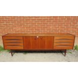 A mid-century Danish teak sideboard, the double doors with turned wooden handles, opening onto a