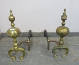 A pair of large antique brass and cast-iron fire dogs, on curved supports. H50cm W17cm D62cm (