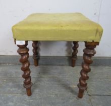 A small 19th century walnut stool, upholstered in pale yellow damask, on tapering barley twist