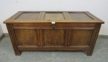 An early 18th century medium oak panelled coffer, retaining the original hinges, on stile