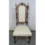 A 19th century rosewood high back hall chair, the carved and pierced back with turned finials and