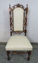 A 19th century rosewood high back hall chair, the carved and pierced back with turned finials and