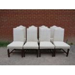 A set of eight antique Georgian Revival mahogany camel back dining chairs, reupholstered in