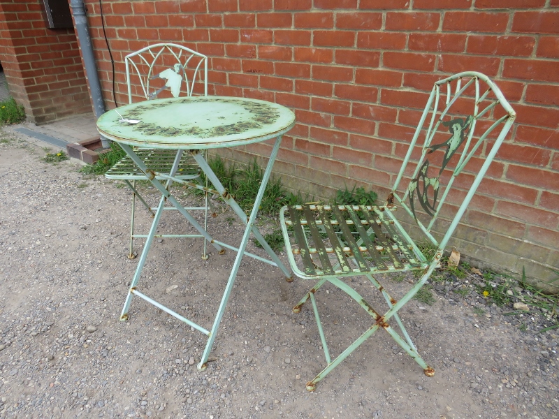 A vintage steel garden set painted green comprising a circular folding table with pierced swallow - Image 3 of 3