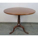 An early Victorian mahogany tilt-top supper table of good colour, on a tapering turned pedestal with