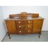 A Regency Revival serpentine fronted mahogany sideboard, the shaped gallery with acanthus carved