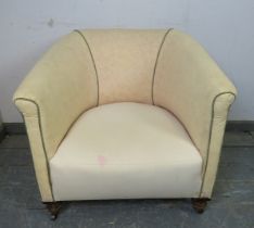 A 19th century tub chair upholstered in calico with green piping, on ball feet with steel castors.