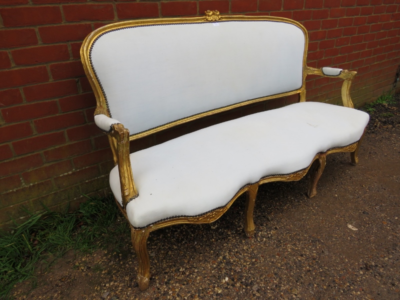 A 19th century French giltwood three-seater sofa, having a serpentine front, reupholstered in calico - Image 2 of 3