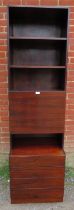 A mid-century Danish hardwood tall drinks cabinet, having three open shelves above a fall-front