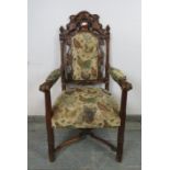 A 19th century oak open-sided armchair, the carved, pierced cornice depicting goats and backrest