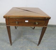 An Edwardian mahogany inlaid and crossbanded envelope card table, having one long frieze drawer,