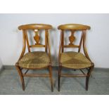 A pair of 19th century provincial French cherrywood side chairs, having shaped splats and curved