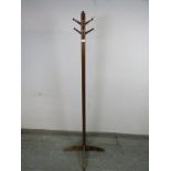 An Art Deco Period mahogany coat stand, having a selection of 10 turned peg hooks, the square column