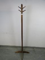 An Art Deco Period mahogany coat stand, having a selection of 10 turned peg hooks, the square column