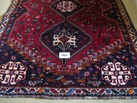 A fine South West Persian Qashqai rug. Three centred triangle motifs on red ground. 240cm x 165cm (