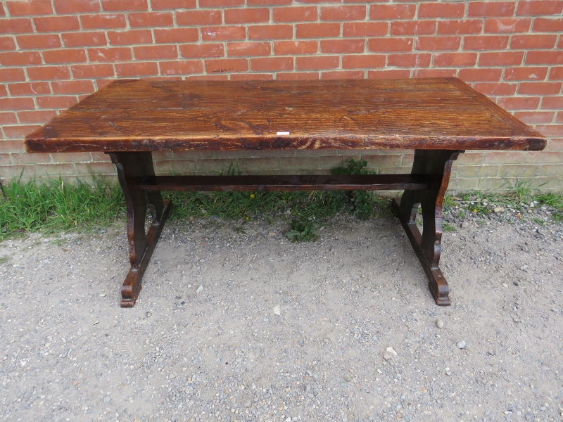 A 19th century elm refectory table of excellent colour and patina, on stile end supports with middle