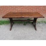 A 19th century elm refectory table of excellent colour and patina, on stile end supports with middle