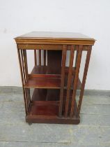 An Edwardian mahogany book table, crossbanded and strung with ebony and boxwood, with batwing