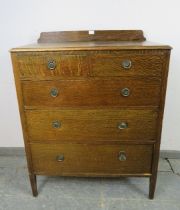 An Edwardian quartersawn oak chest, housing two short above three long graduated oak-lined drawers